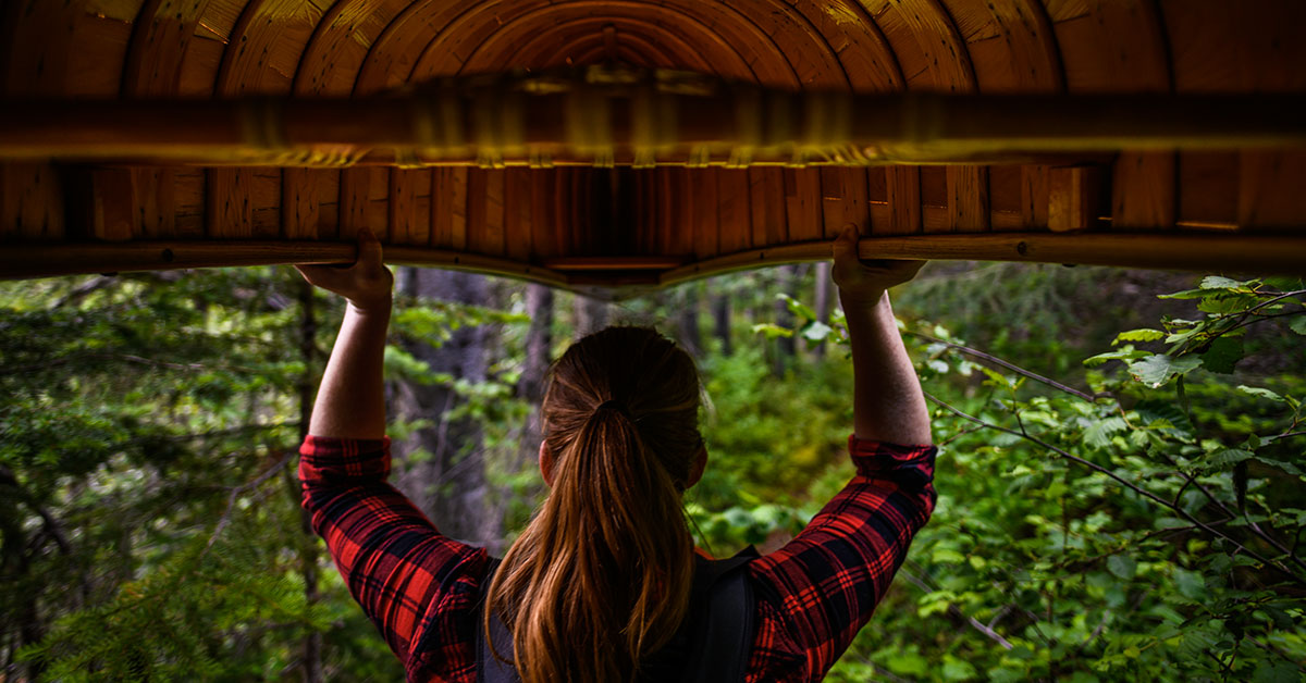 Woman holding Canoe above her head