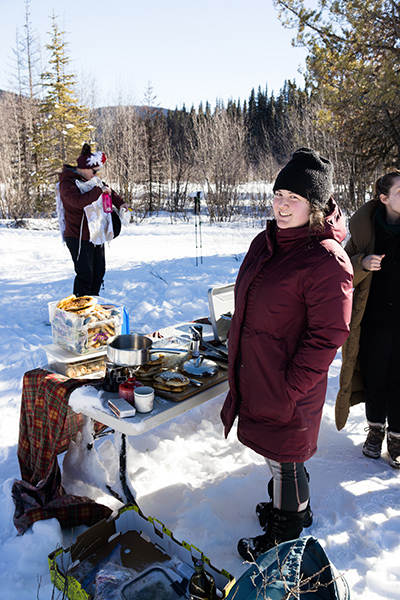 Elyssia Sasaki serving skiers at one of the food stations.